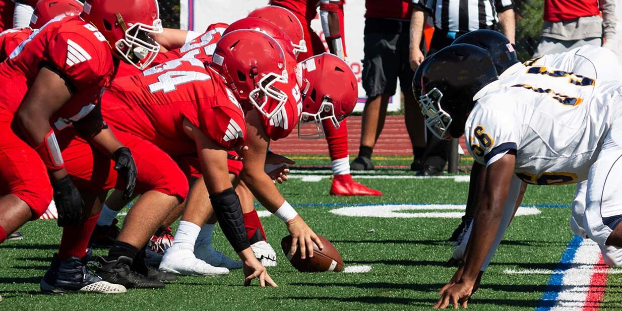 Football teams lined up for the snap of the ball